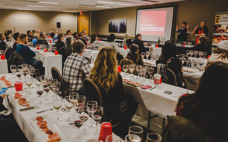 Paricipants in a conference room for a food and drink seminar at Cornucopia Whistler