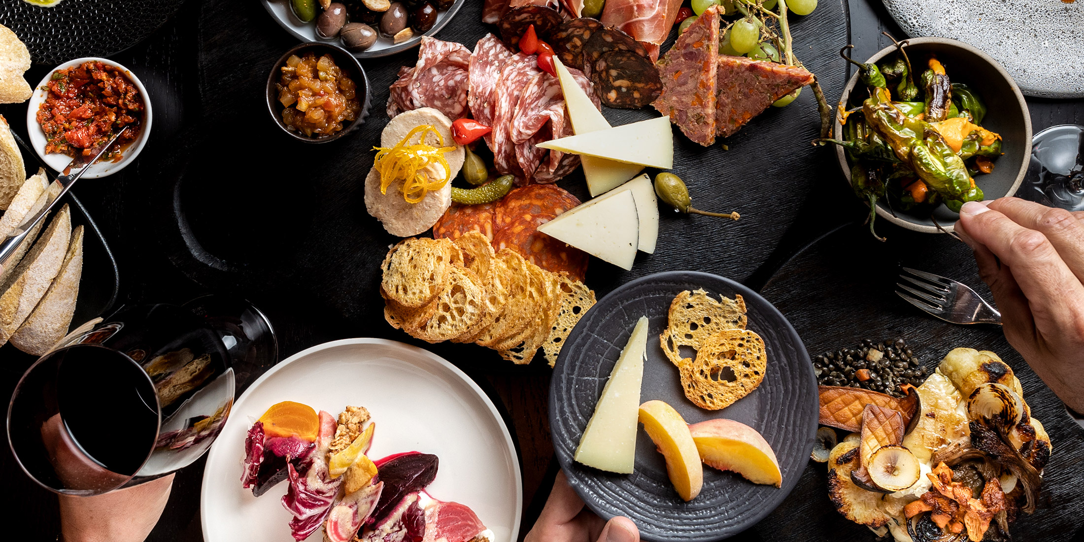 A table filled with food and wine at Cornucopia Whistler Food + Drink Festival