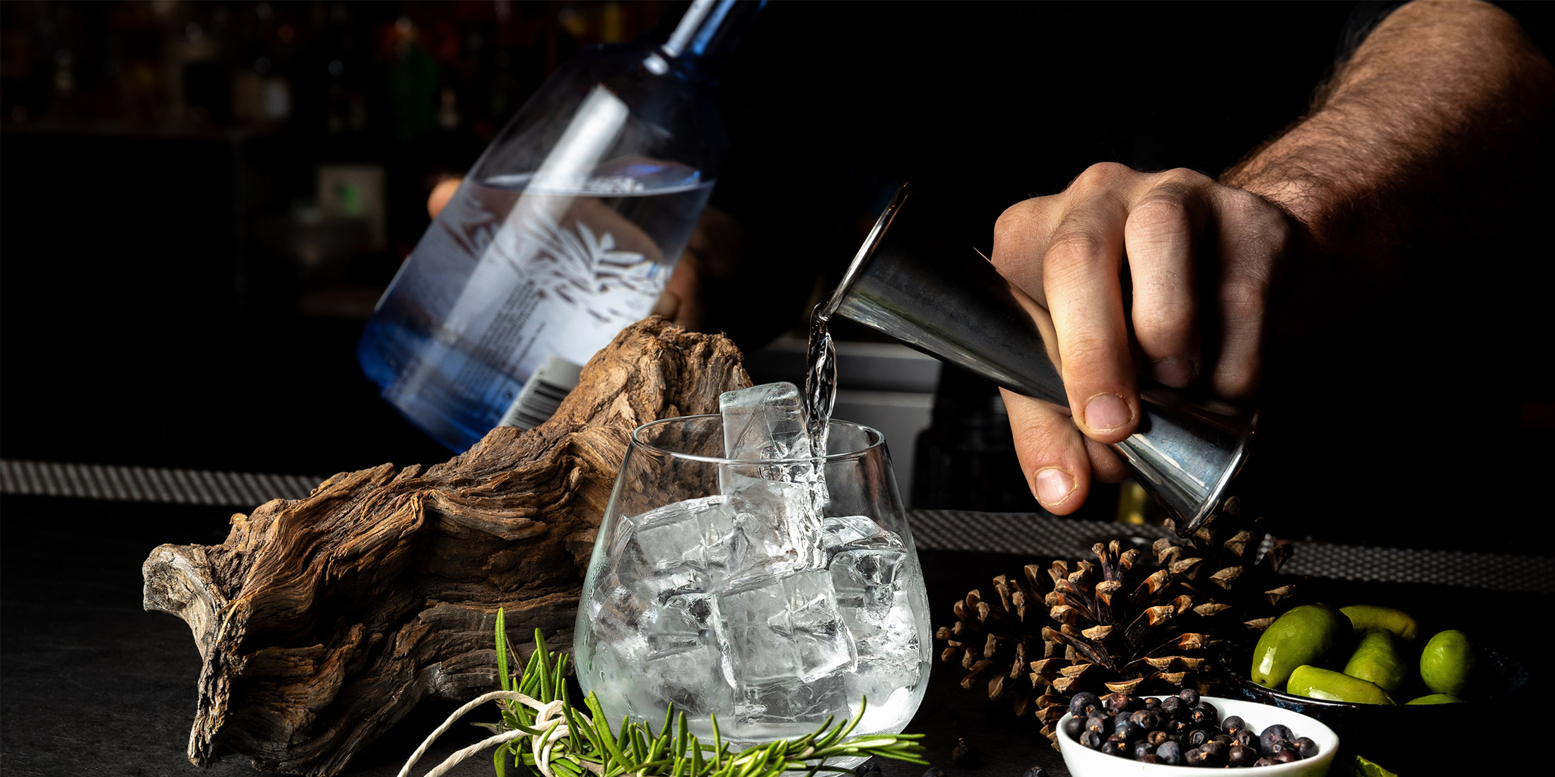 A person's hands shown crafting a cocktail at Cornucopa in Whistler