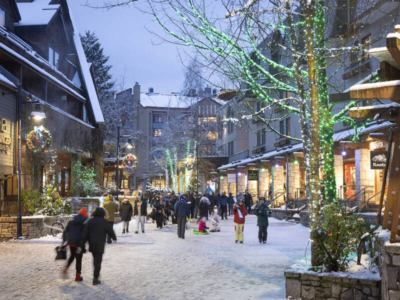 People walking on snowy Whistler Village Stroll during Cornucopia