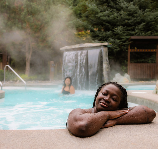Two people enjoying the steaming hot baths at Scandinave Spa in Whistler