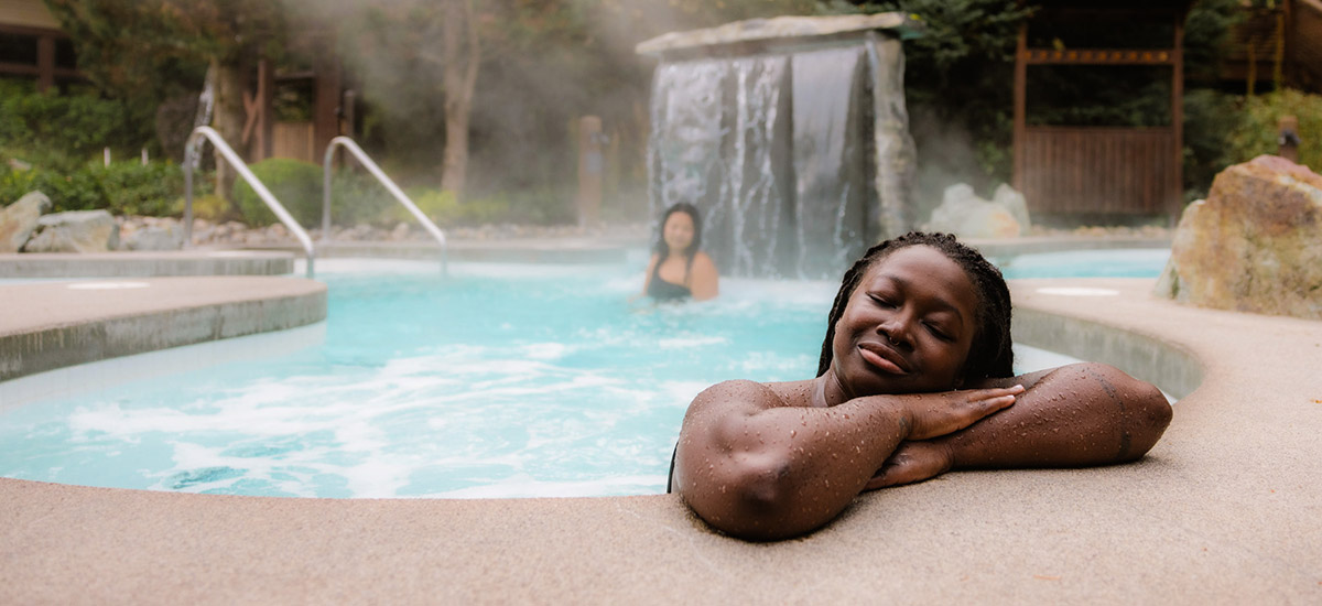 Two people enjoying the steaming hot baths at Scandinave Spa in Whistler